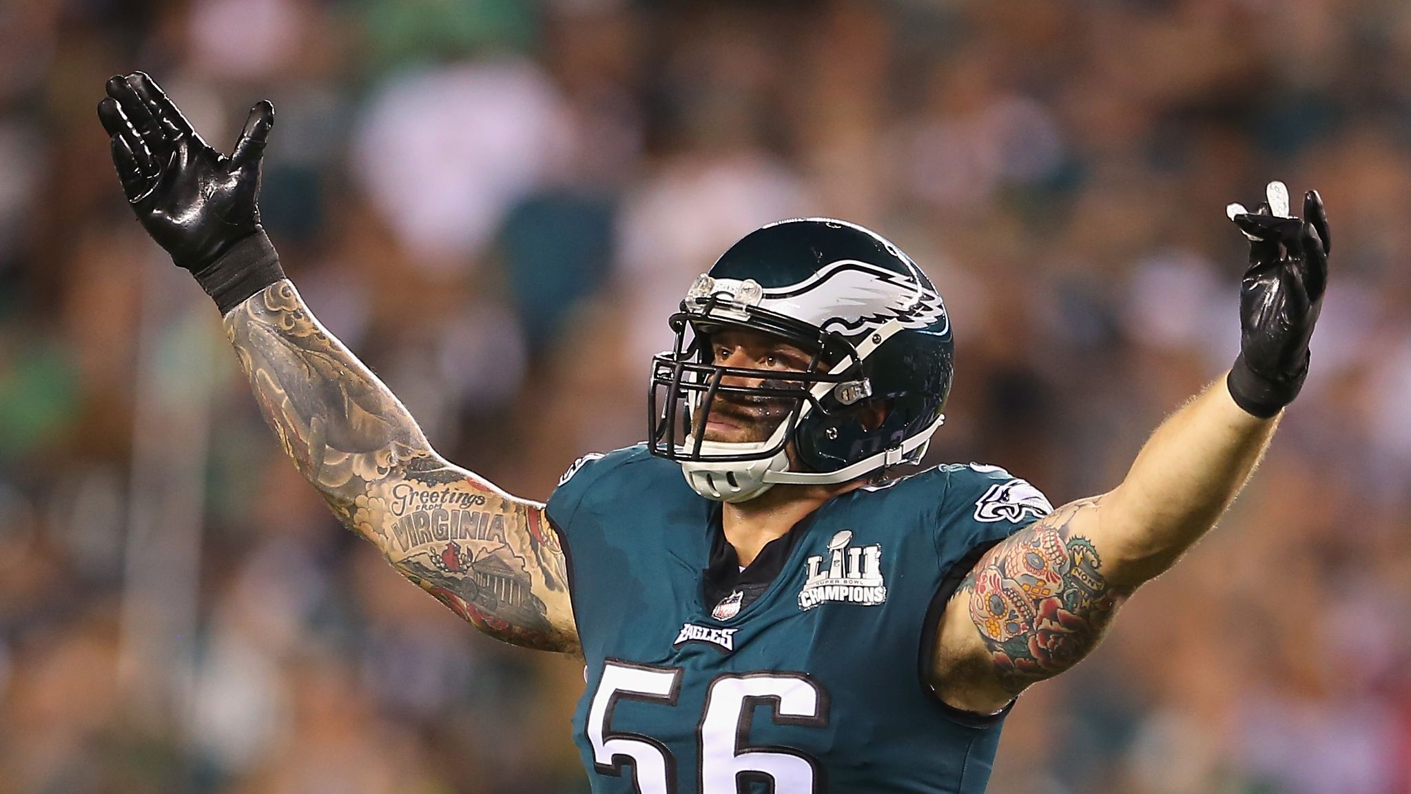 A Super Bowl Champion badge is seen on the chest of Philadelphia Eagles  defensive end Chris Long (56) during the first quarter of an NFL football  game against the Atlanta Falcons at