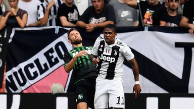 Image of Douglas Costa of Juventus clashes with Sassuolo's Federico Di Francesco during Sunday's Serie A match