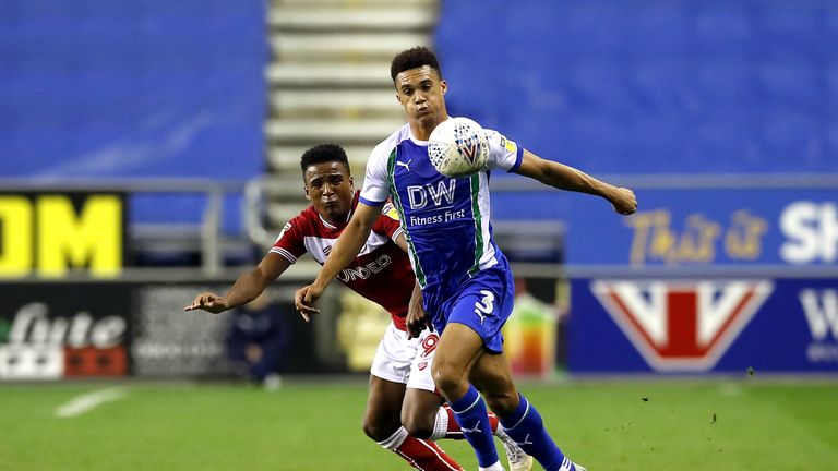 Bristol City's Niclas Eliasson (left) and Wigan's Antonee Robinson (right) battle for the ball