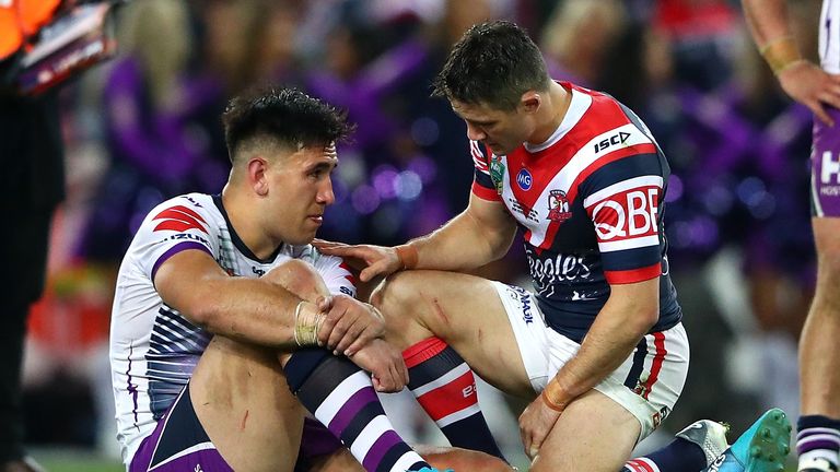 Cooper Cronk of the Roosters consoles Nelson Asofa-Solomona of the Storm