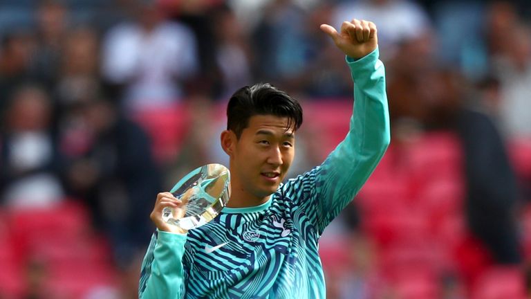 The South Korean presents his medal to the Tottenham fans at Wembley