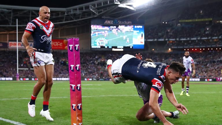 Joseph Manu of the Roosters dives over to score in the corner