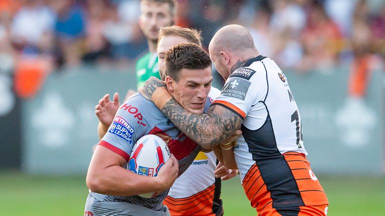  Catalans' Lambert Belmas is tackled by Castleford's Paul McShane & Nathan Massey