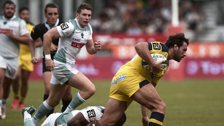 Clermont Auvergne's Remi Lamerat is tackled by Pau's Watisoni Votu during Les Jaunards' latest Top 14 success