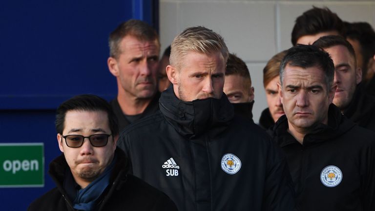 Kasper Schmeichel stands with Vichai Srivaddhanaprabha's son Aiyawatt as they look at floral tributes left to the victims of the helicopter crash
