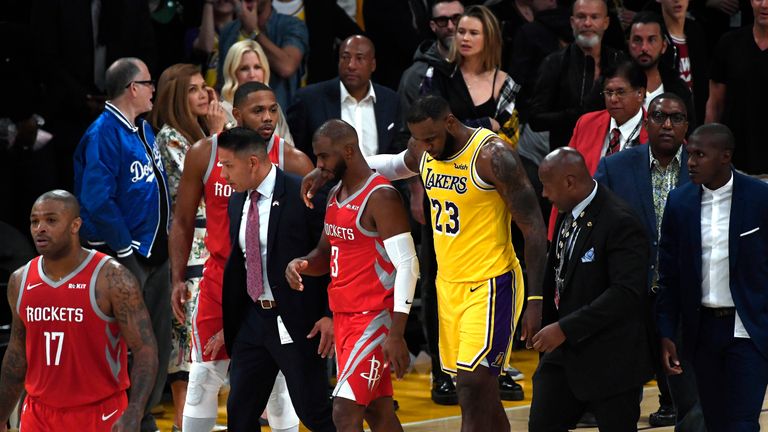 LeBron James guides Chris Paul away after the late brawl between Lakers and Rockets players