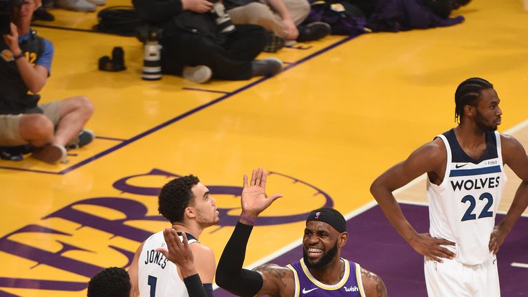 LeBron James high-fives team-mate Josh Hart