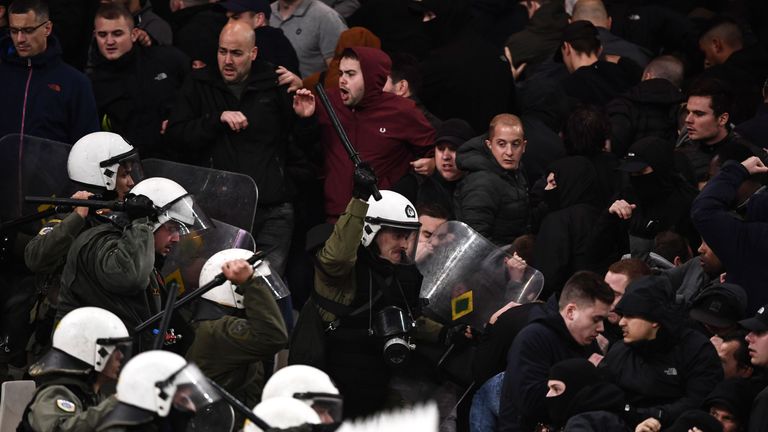 Ajax fans face Greek riot police before the match begins 