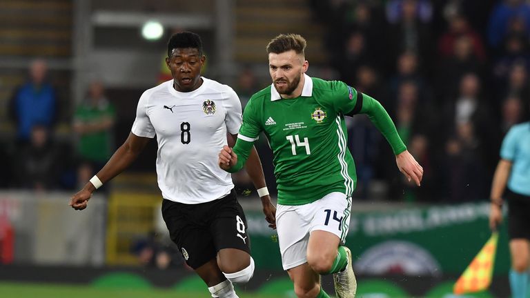 Stuart Dallas and David Alaba compete during the game at Windsor Park