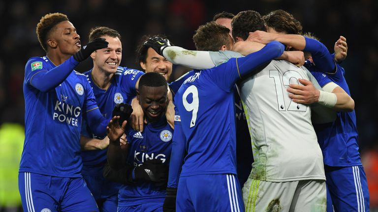 Goalkeeper Danny Ward is invaded by his Leicester teammates after their shootout win