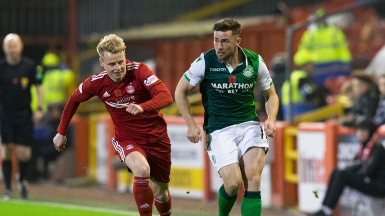 Hibernian's Lewis Stevenson (R) in action with Aberdeen's Gary Mackay-Steven