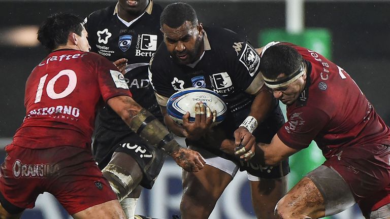 Montpellier's Timoci Nagusa (C) is tackled by  Toulon's  Francois Trinh-Duc (L) and  Guilhem Guirado (R)