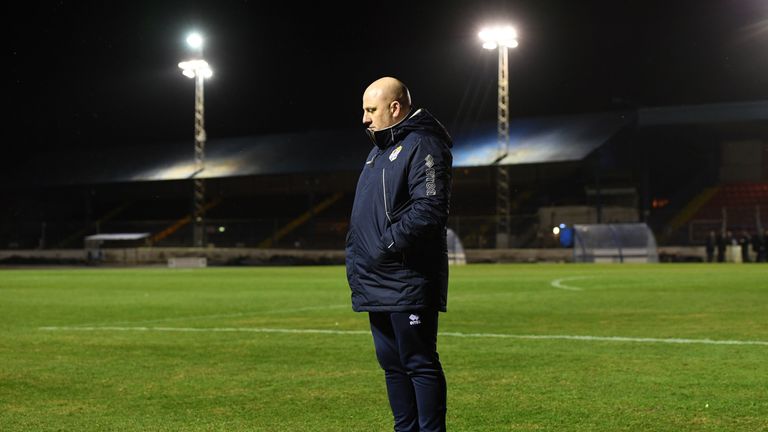 Cowdenbeath manager Gary Bollan inspects the pitch after the game against Rangers is called off