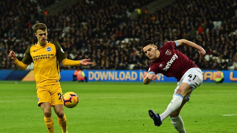 Declan Rice (R) clears the ball