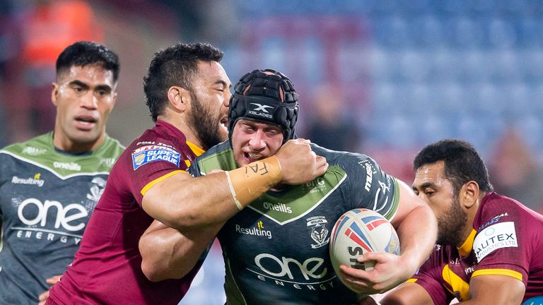 Chris Hill is tackled by Huddersfield's Suai Matagi during the contest