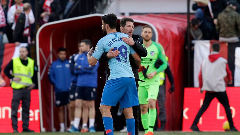 Diego Simeone embraces Diego Costa after the match between Rayo Vallecano and Atletico Madrid