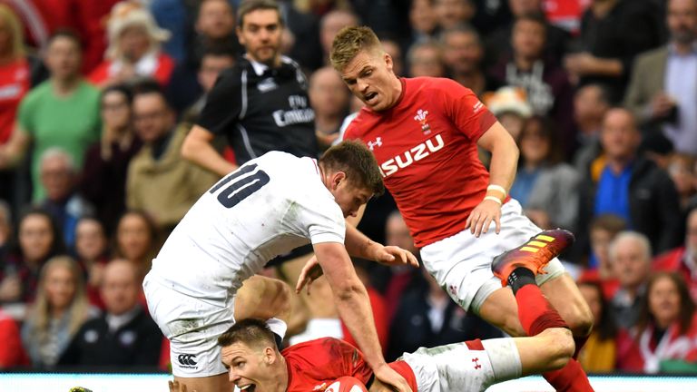 Wales' Liam Williams secures a loose ball under pressure from England's Owen Farrell