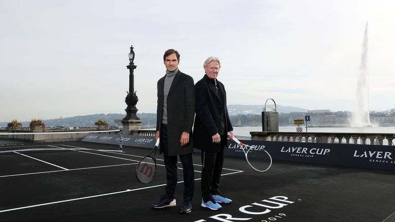 Federer and Team Europe skipper Bjorn Borg pose on the black court in Geneva