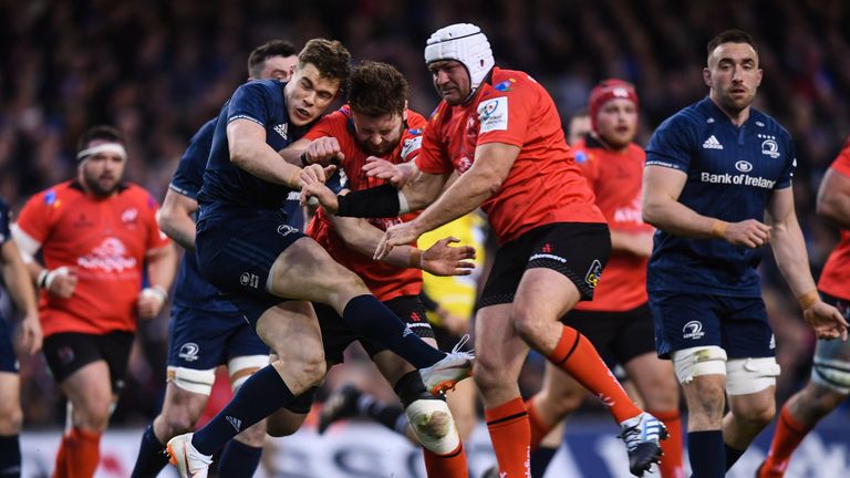 Garry Ringrose of Leinster has his kick blocked down by Iain Henderson and Rory Best of Ulster 