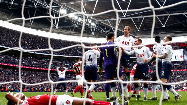 Hugo Lloris celebrates with team-mates after saving a late penalty while a dejected Pierre-Emerick Aubameyang lies nearby