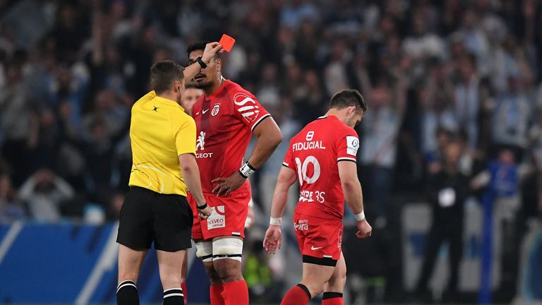 Zack Holmes of Toulouse is shown a red card 