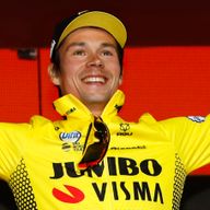 Primoz Roglic celebrates on the podium after winning stage one of the Giro d'Italia