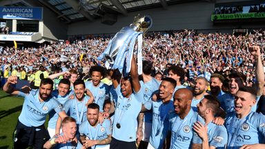 Fernandinho celebrates with the Premier League trophy