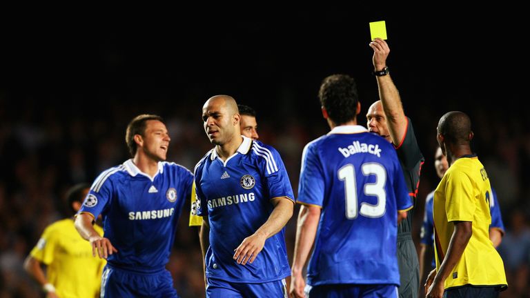 Chelsea defender Alex is shown a yellow card during a bad-tempered match