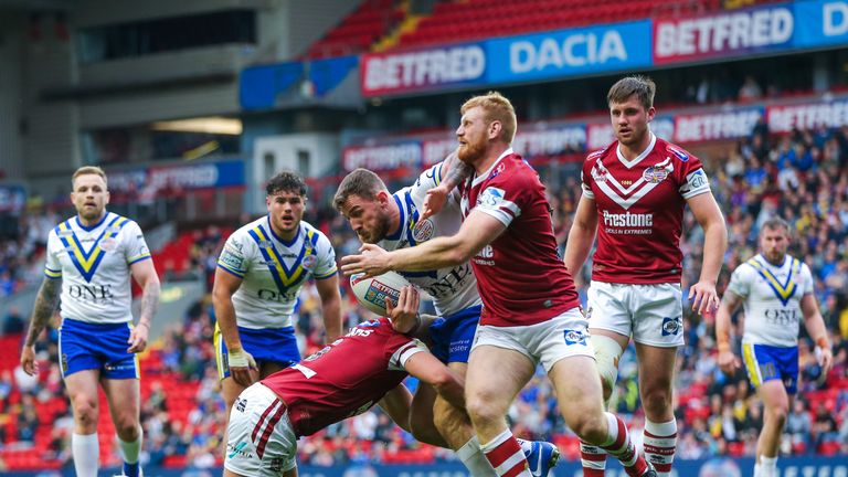 Warrington's Daryl Clark tries to find a way through the Wigan defence
