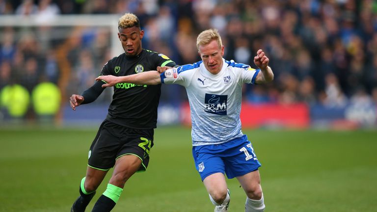 Tranmere's David Perkins and Forest Green striker Junior Mondal battle for possession