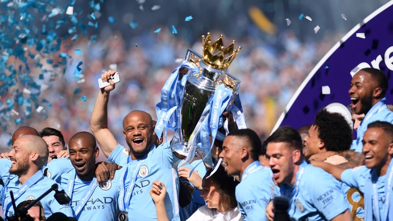 Kompany lifts the Premier League title for the fourth time during his City career