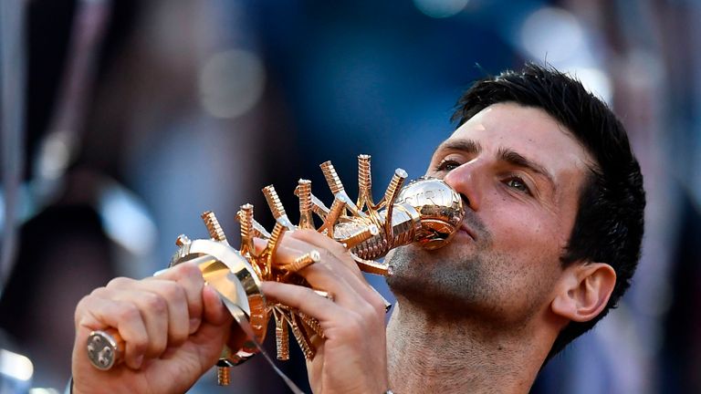 Novak Djokovic celebrates with the Madrid Open trophy after a ruthless display