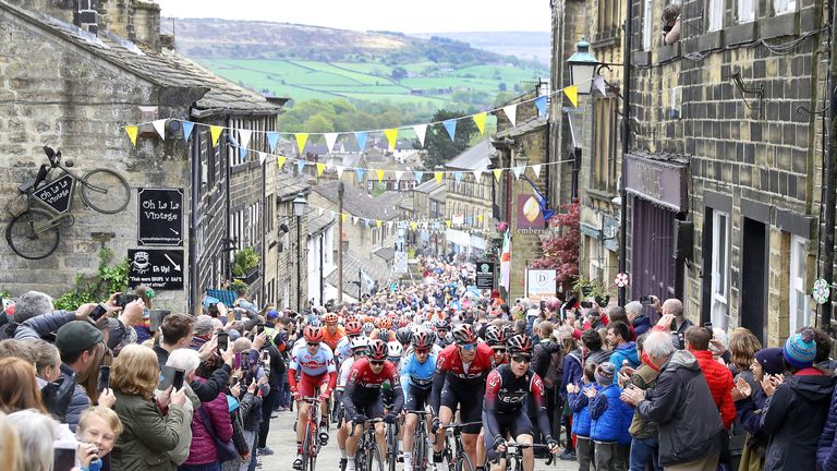Team Ineos lead the peloton, including leader Lawless, as they climb a hill in Haworth