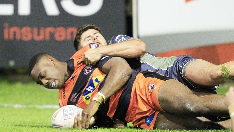 Tuoyo Egodo scores a try as he is tackled by Warrington's Jack Johnson