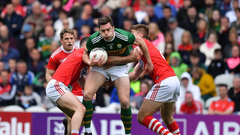 David Moran of Kerry bursts past Nathan Walsh and Ian Maguire of Cork