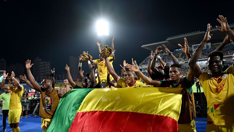 Benin players celebrate after qualifying for the round of 16