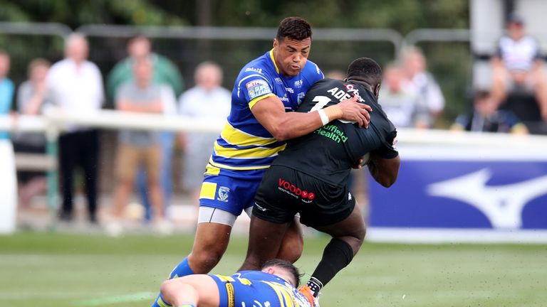 Warrington's Luther Burrell defends against Sadiq Adebiyi