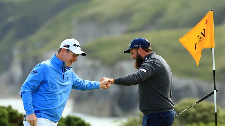 Bob MacIntyre celebrates his eagle at the fifth with Andrew Johnston during the first round