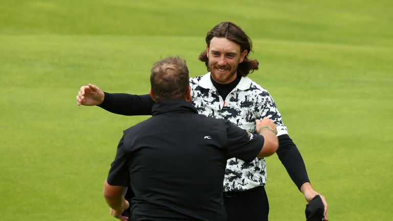 Fleetwood hugs champion Shane Lowry on the 18th green