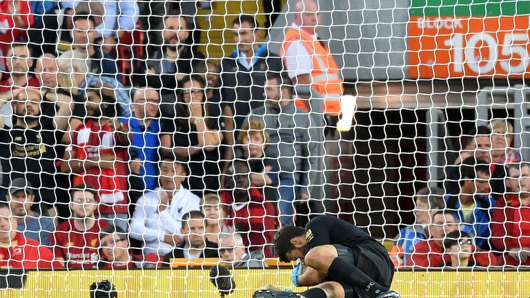 Alisson goes down with an injury during Liverpool's match vs Norwich City