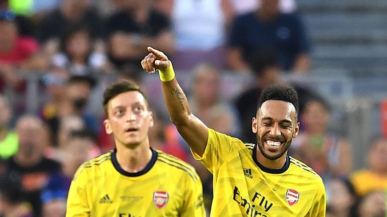 Pierre-Emerick Aubameyang celebrates with Arsenal team-mate Mesut Ozil after scoring against Barcelona