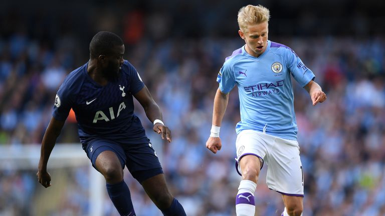 Tanguy Ndombele looks on as Oleksandr Zinchenko controls the ball