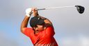 Reed leads as Woods charges