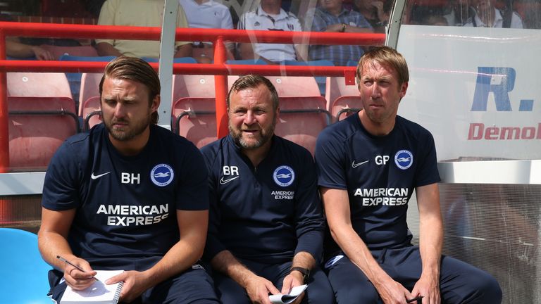 Reid on the Brighton bench alongside Bjorn Hamberg and Graham Potter
