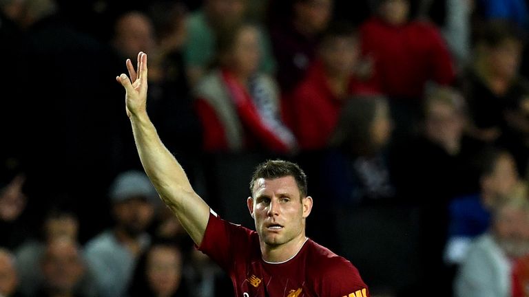 James Milner celebrates after scoring four minutes before the break