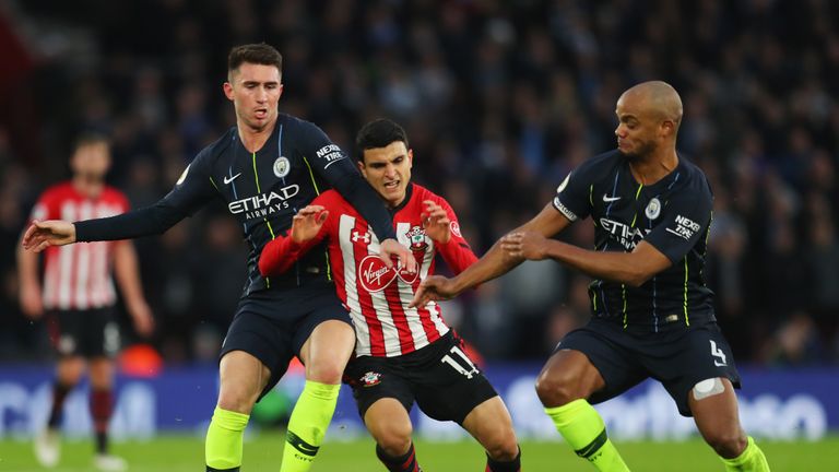 Vincent Kompany (right) playing alongside Laporte (left) for City last season