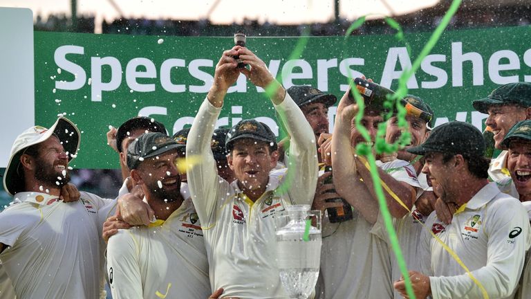 Tim Paine lifts the Ashes urn at The Oval after the series ends in a 2-2 draw