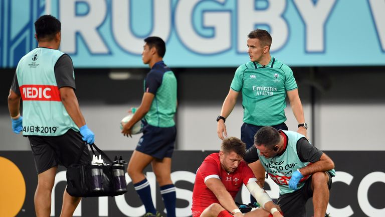 Biggar receiving medical attention during the Pool D game