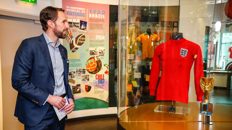 Gareth Southgate looks on at memorabilia ahead of England's 1,000th international