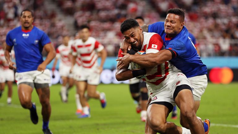 Timothy Lafaele holds off Alapati Leiua's tackle to score the opening try